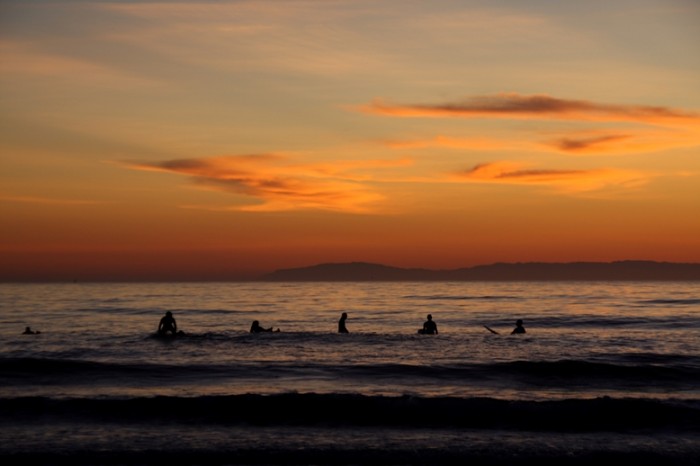 Surfers at dusk